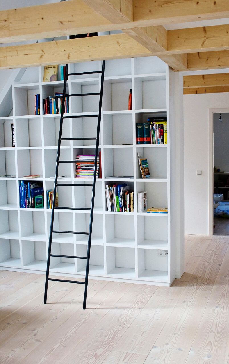 Living room with light wooden floor made out of douglas and bookshelf